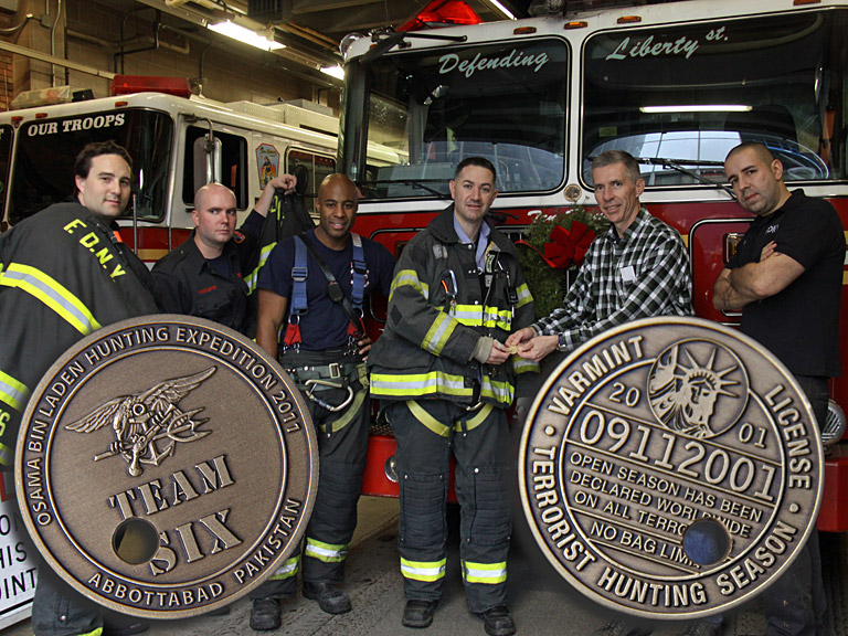 Captain Murray C. Norcross, USN, presents the Punched Ticket Osama bin Laden Challenge Coin to the Ten House